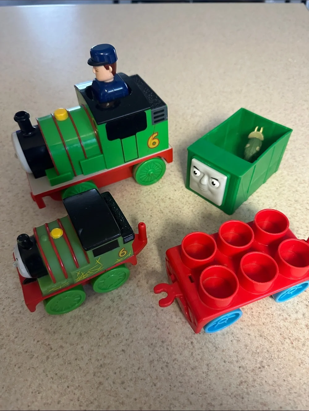 Green Percy the Small Engine toys and cargo cars from Thomas & Friends.
